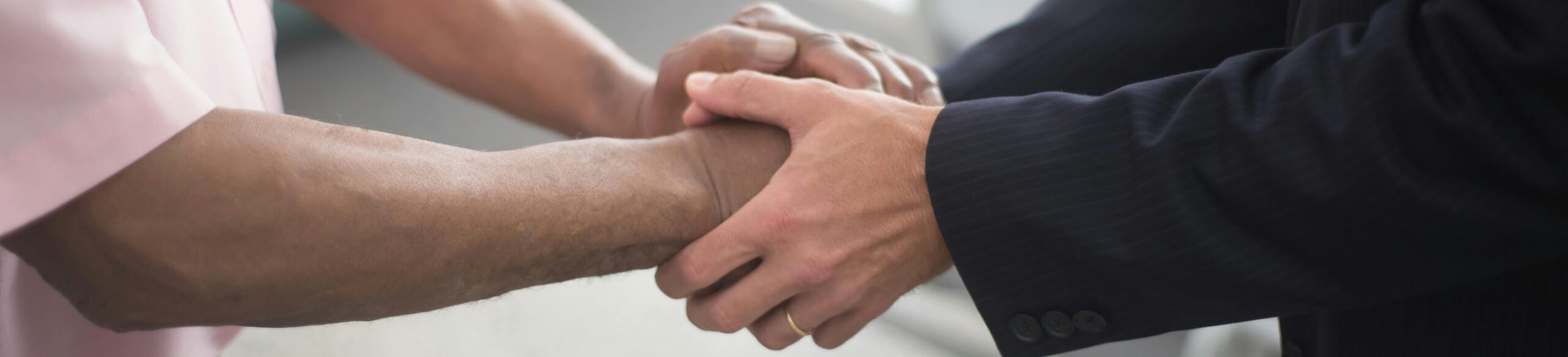 a close up of hands holding a person's hand